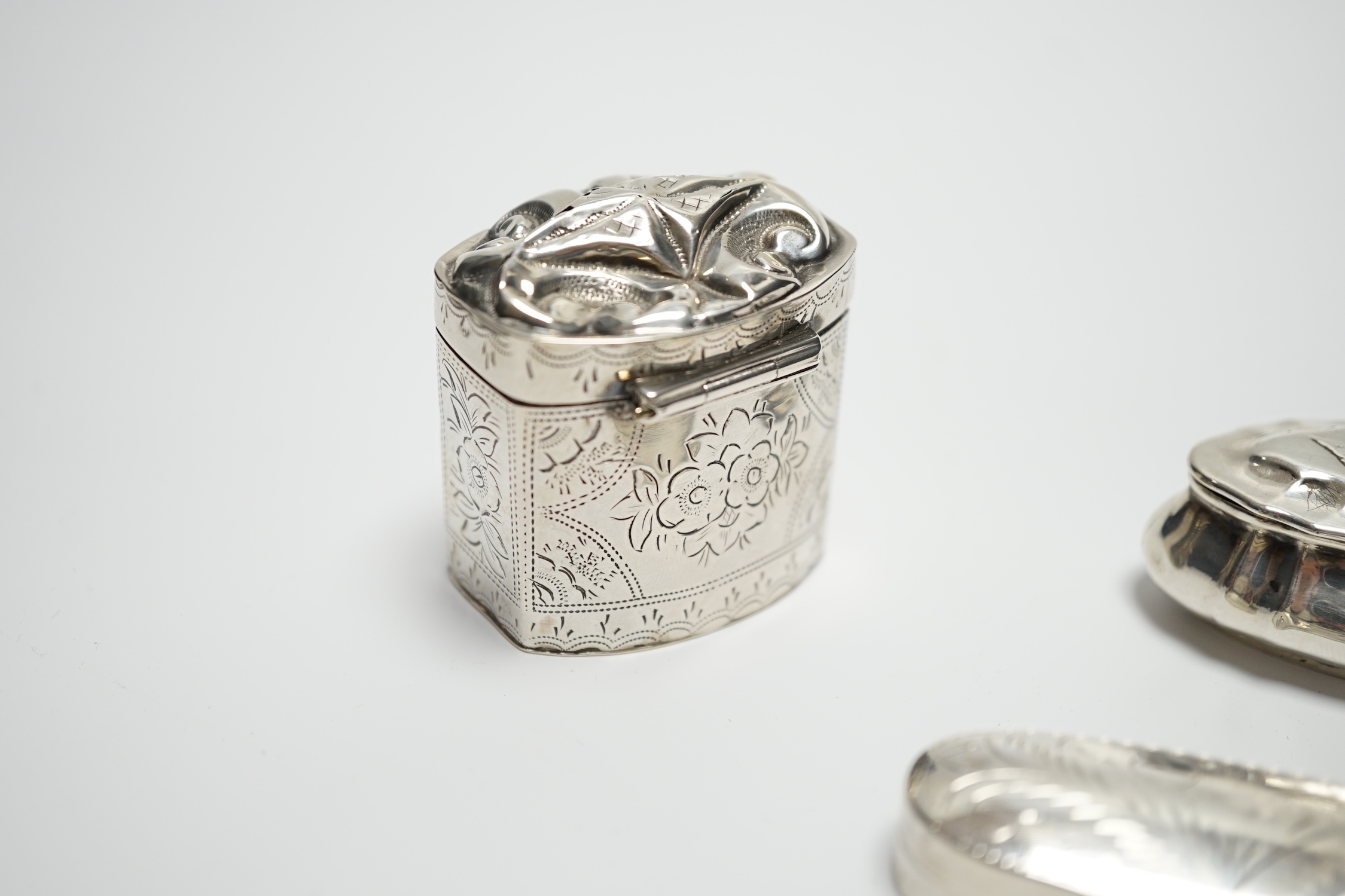 A late Victorian silver pill box with Reynold's Angel decorated cover, 47mm, a modern silver pill box and a Dutch white metal box.